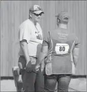  ?? Tim Conover ?? Nebraska One Box Rock Crusher Assistant Coach Jim Duncan and his son Samuel Duncan who shoots for Hastings College get ready for the second day of shooting.