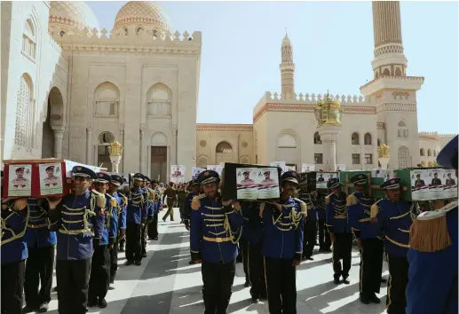  ?? (Khaled Abdullah/Reuters) ?? HONOR GUARDS carry coffins of Houthis killed fighting government forces in Yemen’s oil-rich province of Marib, during a funeral procession in Sana’a last week.