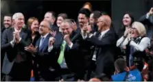  ?? PAVEL GOLOVKIN — THE ASSOCIATED PRESS ?? Delegates of Canada, Mexico and the United States celebrate after winning a joint bid to host the 2026 World Cup at the FIFA congress in Moscow, Russia, Wednesday. Standing on front row from left: Steve Reed, president of the Canadian Soccer Associatio­n, Carlos Cordeiro, U.S. soccer president and Decio de Maria, President of the Football Associatio­n of Mexico.