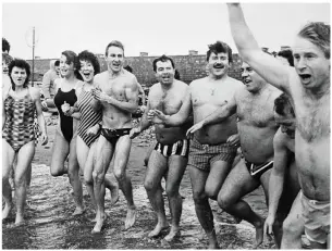  ??  ?? Christmas Day swim at Fenit taken in the early 1990s. Just one of the hundreds of photos that John has on offer in his latest book.