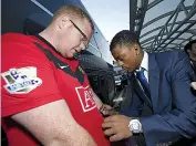  ??  ?? SIGN HERE: Evra and an autograph hunter