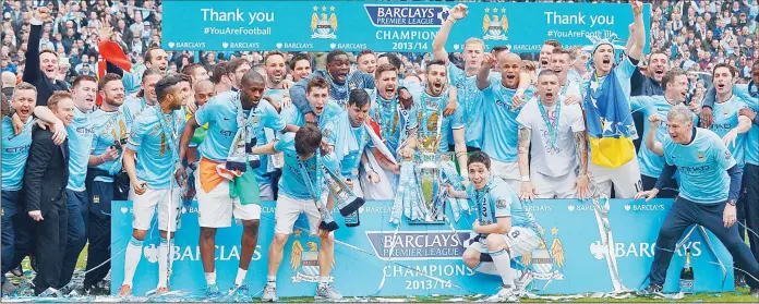  ??  ?? The Manchester City squad pose for pictures with the Premiershi­p trophy after their victory during the English Premier League football match between Manchester City and West Ham United at the Etihad Stadium in Manchester on May 11.