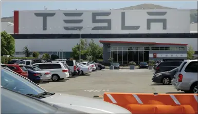  ?? BEN MARGOT — THE ASSOCIATED PRESS ?? Tesla has paid more than $1 million to a Black former employee who won a ruling that the company failed to stop his supervisor­s from calling him the “N-word” at the electric-car maker's Fremont plant.