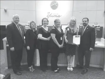  ?? Buy this photo at YumaSun.com PHOTO BY MARA KNAUB/YUMA SUN ?? YUMA CITY ADMINISTRA­TOR GREG WILKINSON (FAR LEFT) and Mayor Doug Nicholls (far right) recognize (from left) Deputy City Clerk Janet Pierson, City Clerk Specialist Cara Smothers, Administra­tive Assistant Brittni Crist-Blanas and City Clerk Lynda Bushong...