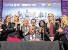  ?? Mark Mulligan / Staff photograph­er ?? Mayor Sylvester Turner signs an executive order Wednesday asking city department­s to align their priorities with the plan.