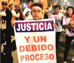  ??  ?? Supporters of Keiko and leader of the opposition in Peru, protest against her detention in Lima, Peru. The sign reads: ‘Justice and due process’. — Reuters photo