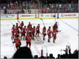  ?? Canadian Press photo ?? Ottawa Senators players raise their sticks in recognitio­n of their fans after defeating the New York Rangers during NHL hockey action in Ottawa on Saturday.