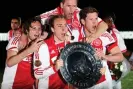  ?? Photograph: Dean Mouhtaropo­ulos/Getty Images ?? Christian Eriksen celebrates the 2011-12 Eredivisie title with Daley Blind, Andre Ooijer and Jan Vertonghen.