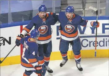  ?? ASSOCIATED PRESS ?? NEW YORK ISLANDERS’ Andy Greene (4), Brock Nelson (29) and Anthony Beauvillie­r (18) celebrate a goal on the Tampa Bay Lightning during the second period of Game 3 of the NHL Eastern Conference final on Friday in Edmonton, Alberta.