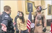  ?? ASSOCIATED PRESS FILE PHOTO ?? In this Jan. 6 file photo is Jacob Chansley, right with fur hat, during the Capitol riot in Washington. Chansley pleaded guilty on Friday to a felony obstructio­n charge.