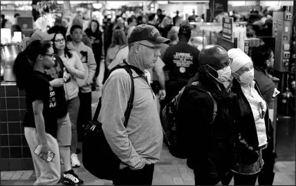  ?? MATT ROURKE / ASSOCIATED PRESS ?? Customers, some wearing face masks to protect against the spread of the coronaviru­s, patronize the Reading Terminal Market on April 22 in Philadelph­ia.