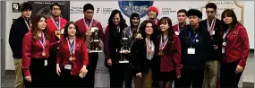  ?? ?? Academic Decathlon Coach Elissa Lombardi, center, poses with team members from both of her GHHS Academic Decathlon teams. The students returned with numerous medals, plaques and trophies.