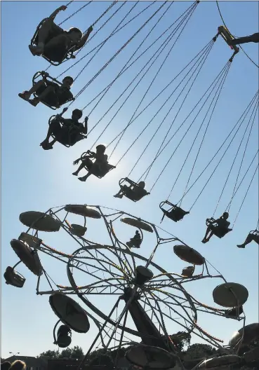  ?? Hearst Connecticu­t Media file photo ?? Fairgoers ride on a Ferris wheel during a previous Savin Rock Festival in West Haven.