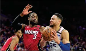  ?? DREW HALLOWELL / GETTY IMAGES ?? Philadelph­ia’s Ben Simmons drives on Miami’s Dwyane Wade during a playoff game in Philadelph­ia on Wednesday. Wade’s return for 21 games this season helped get the Heat into the playoffs.