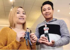  ??  ?? Nhu and Hoang Nguyen recently opened 3D Teeny Me, a shop that sells figurines made to look like customers. The couple are shown with miniature versions of themselves.