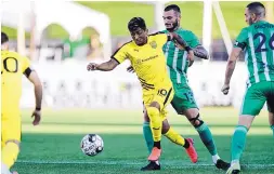  ?? OKC ENERGY COURTESY PHOTO ?? Amando Moreno of New Mexico United fights off an OKC Energy player during first-half action in Oklahoma City on Saturday night. Moreno had a goal in United’s 3-0 victory.