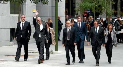  ?? PHOTO: REUTERS ?? Dismissed Catalan foreign affairs chief Raul Romeva waves as he arrives with other dismissed cabinet members at Spain’s High Court after being summoned to testify on charges of rebellion, sedition and misuse of public funds.