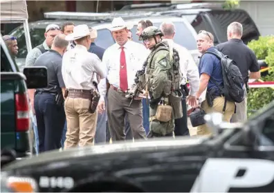  ?? Associated Press ?? ABOVE: Law enforcemen­t officers from multiple Central Texas agencies respond Monday to reports of an officer down in Round Rock, Texas. Sgt. Craig Hutchinson with the Travis County Sheriff’s Office was shot and killed at his home north of Austin before...