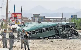  ?? REUTERS ?? Afghan security forces inspect the damage to buses hit by suicide bombers at the site of an attack on the western outskirts of Kabul on Thursday.