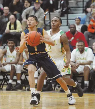  ?? STAFF PHOTO BY CHRISTOPHE­R EVANS ?? DRIVING HARD: St. Mary’s Jalen Echevarria heads to the bucket past Cathedral’s Victor Owens during the second quarter of last night’s the Division 4 state semifinal at Woburn High.