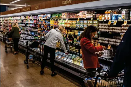  ?? ?? People shop at a grocery store in Scottsdale, Arizona, on 3 January. Photograph: Bloomberg/Getty Images