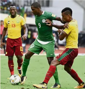 ??  ?? Nigeria’s Odion Ighalo (centre) vying for the ball with Cameroon players during their Group B World Cup qualifying match at the Godswill Akpabio Internatio­nal Stadium in Uyo, Nigeria, on Monday. — AFP Keep off!: