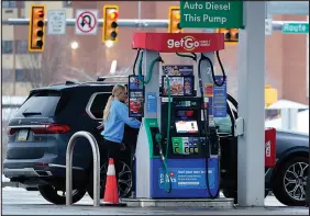  ?? GENE J. PUSKAR / ASSOCIATED PRESS ?? A woman pumps gas Jan. 23 at a Getgo Mini Mart in Valencia, Pa.