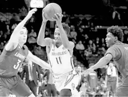  ?? ABBIE PARR/GETTY IMAGES ?? Braian Angola, going against Louisville’s Ryan McMahon (30) and Darius Perry, scored 9.