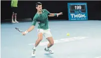  ?? ALANA HOMBERG THE NEW YORK TIMES ?? Novak Djokovic hits a forehand return shot during his victory over Alexander Zverev at the Australian Open on Tuesday.