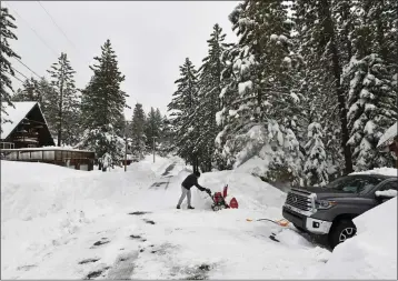  ?? NDY BARRON— THE ASSOCIATED PRESS ?? Pat Setter works on digging out his trash container outside his home at Donner Lake on Monday in Truckee. A powerful blizzard that closed highways and ski resorts had moved through the Sierra Nevada by early Monday, but forecaster­s warned that more snow was on the way for the Northern California mountains.