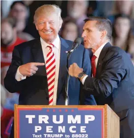  ?? | GETTY IMAGES ?? Then- Republican presidenti­al candidate Donald Trump jokes with retired Gen. Michael Flynn as they speak at a rally in October 2016 in Grand Junction, Colorado.