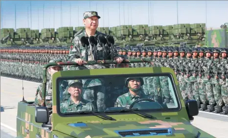  ?? LI GANG / XINHUA ?? President Xi Jinping, who also is general secretary of the Communist Party of China Central Committee and chairman of the Central Military Commission, inspects military units before the parade at the Zhurihe Training Base in North China’s Inner...