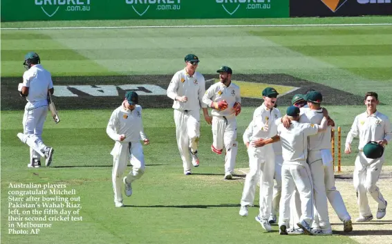  ?? Photo: AP ?? Australian players congratula­te Mitchell Starc after bowling out Pakistan’s Wahab Riaz, left, on the fifth day of their second cricket test in Melbourne