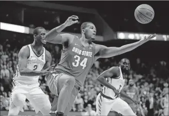  ?? [JEFF ROBERSON/THE ASSOCIATED PRESS] ?? Ohio State’s Kaleb Wesson grabs a rebound between Iowa State’s Cameron Lard, left, and Marial Shayok during Buckeyes’ 62-59 victory on Friday night in Tulsa, Okla.