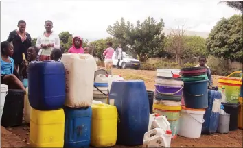  ??  ?? Children queue with buckets to fetch water from a church borehole in Dzivaresek­wa yesterday. Harare City Council shut down its main water treatment plant, Morton Jaffray Waterworks, for two days at the weekend to allow for the repair of mains at Warren...