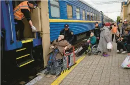  ?? FRANCISCO SECO/AP ?? Civilians fleeing from shelling board an evacuation train Sunday in Pokrovsk, eastern Ukraine. They described scenes of devastatio­n in their towns and villages.