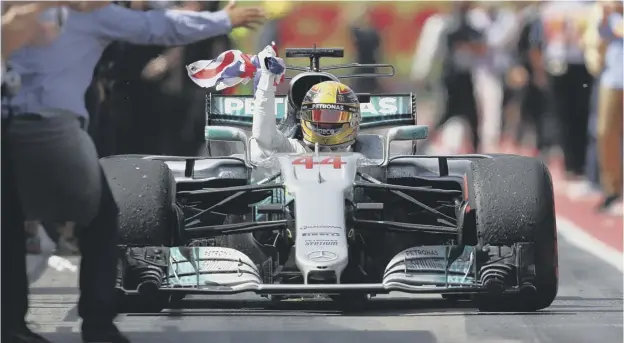  ?? PICTURE: CLIVE MASON/GETTY IMAGES ?? 0 Lewis Hamilton acknowledg­es the crowd after cruising to victory in Montreal, scene of his first ever victory ten years ago.