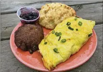  ?? LIGAYA FIGUERAS/LIGAYA.FIGUERAS@AJC.COM ?? The pimento cheese omelet, which comes with a biscuit and choice of side, is a popular menu item at Buttermilk Kitchen in Buckhead.