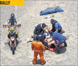  ??  ?? Sam Sunderland (C) is assisted by medical staff after a crash during Stage 4 of the Dakar Rally in and around San Juan De Marcona, Peru.