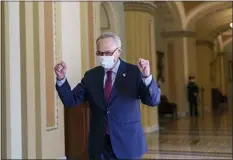  ?? J. SCOTT APPLEWHITE — THE ASSOCIATED PRESS ?? Senate Majority Leader Chuck Schumer, D-N.Y., leaves the chamber just after the Senate narrowly approved a $1.9 trillion COVID-19relief bill, at the Capitol in Washington, Saturday, March 6, 2021.