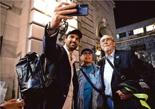  ?? Photos by Scott Strazzante/The Chronicle ?? Terri and Bob Ryan are photograph­ed by cast member Jonathan Tetelman after a performanc­e of “La Traviata” at the War Memorial Opera House.