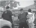  ?? GREGORY BULL/AP ?? U.S. Immigratio­n and Customs Enforcemen­t officers detain a man July 8 during an operation in Escondido, Calif. The Trump administra­tion announced Monday that it will vastly expand the authority of immigratio­n officers to deport migrants without allowing them to first appear before judges.