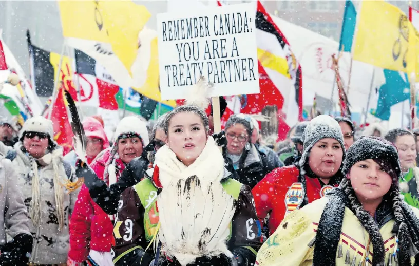  ?? JULIE OLIVER/OTTAWA CITIZEN ?? Idle No More protesters make their way through downtown Ottawa to Parliament Hill in January. The protesters had just met with Attawapisk­at Chief Theresa Spence, who was on a hunger strike.