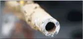  ?? PAUL SANCYA/AP ?? A lead pipe after being replaced by a copper water supply line to a home in Flint, Michigan, in July 2018.