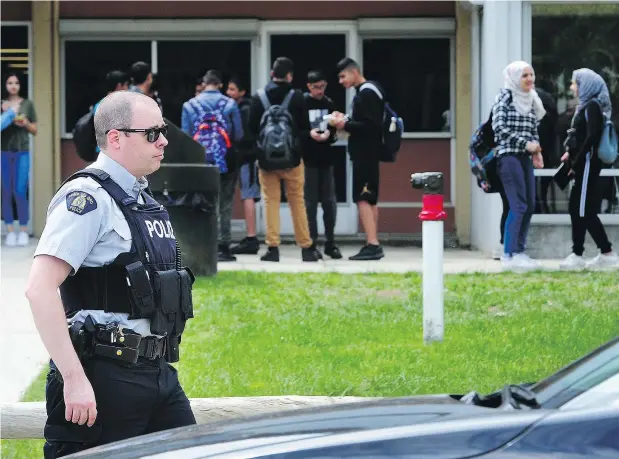  ?? — NICK PROCAYLO ?? RCMP officers were on the scene at Frank Hurt Secondary School where grief counsellor­s have been called in following the violent deaths of Jaskarn (Jason) Singh Jhutty, 16, and Jaskaran (Jesse) Singh Bhangal, 17.