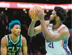  ?? NELL REDMOND/AP ?? Philadelph­ia 76ers center Joel Embiid puts up a shot as Charlotte Hornets forward Kai Jones defends during Friday’s game in Charlotte.