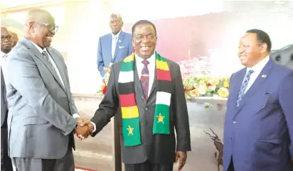  ?? ?? The President greets Rwandan Ambassador to Zimbabwe James Musoni while Foreign Affairs and Internatio­nal Trade Minister Frederick Shava looks on at the New Year reception for heads of diplomatic missions in Harare yesterday