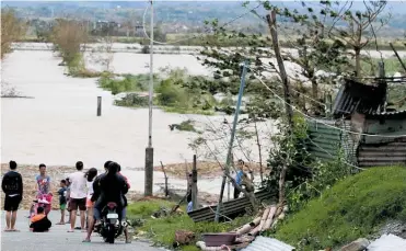  ?? Photos / AP ?? Floodwater­s from Typhoon Mangkhut leave residents stranded in Tuguegarao city in Cagayan province, northeaste­rn Philippine­s.