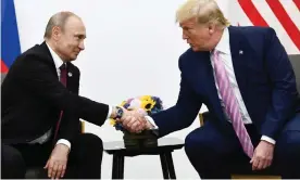  ??  ?? Vladimir Putin (left) with Donald Trump at a G20 summit, June 2019. Photograph: Brendan Smialowski/AFP/Getty Images