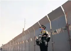  ??  ?? STANDING ALERT: A police officer stands guard next to fences placed outside the National Palace ahead of expected violence in a Women’s Day protest on Friday.